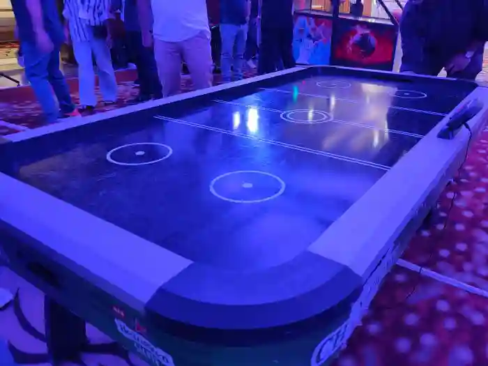 Guests playing air hockey at a Noida celebration