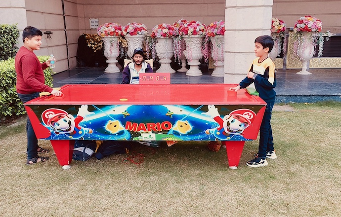 Guests playing air hockey at a Lucknow celebration