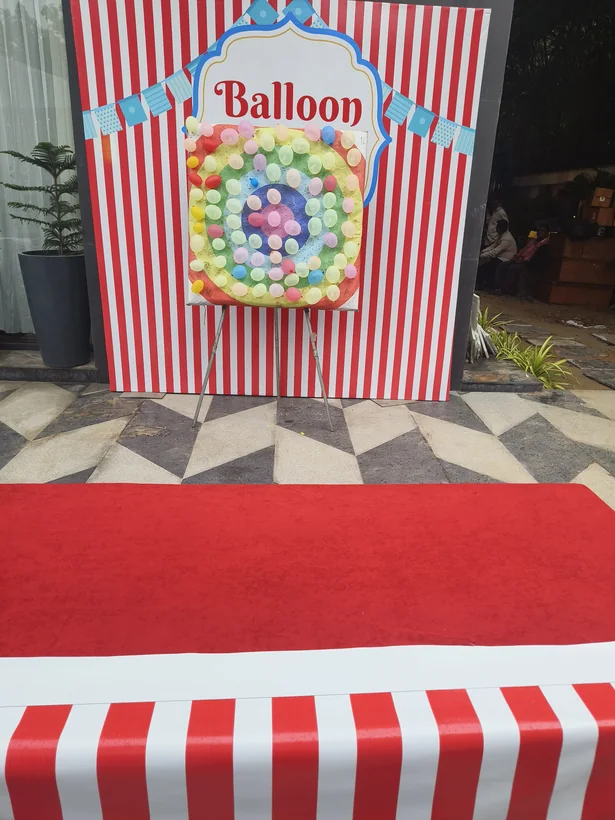Balloon shooting game with striped event backdrop prepared in Lucknow