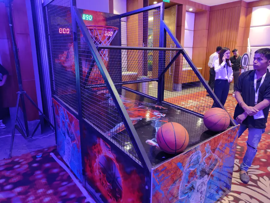 Guests enjoying electronic basketball game during a Jaipur celebration