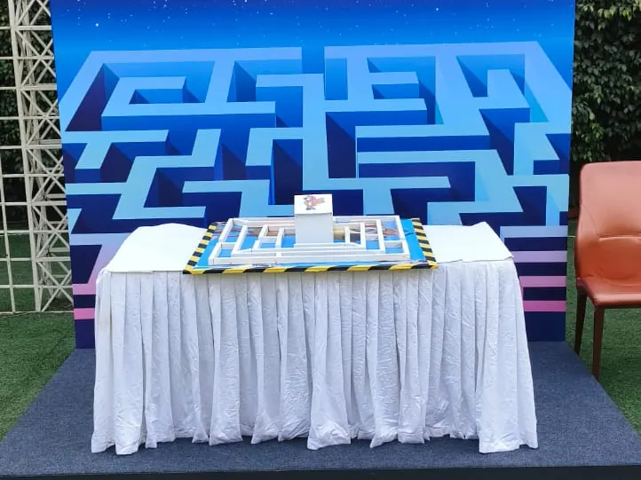 Tabletop maze game arranged with a themed backdrop for a Mumbai event