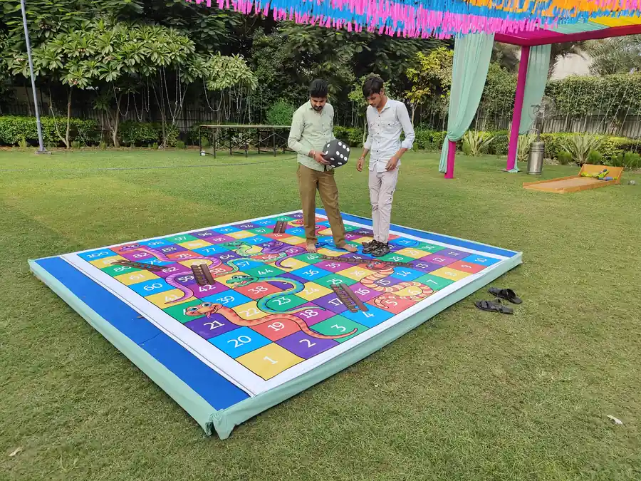 Guests playing giant snake and ladder