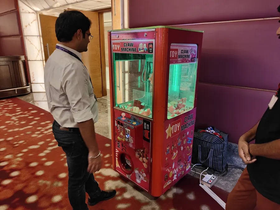 Guest using a toy claw machine at an event